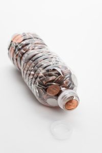 7493230 - plastic bottle and coins,dollar with white background